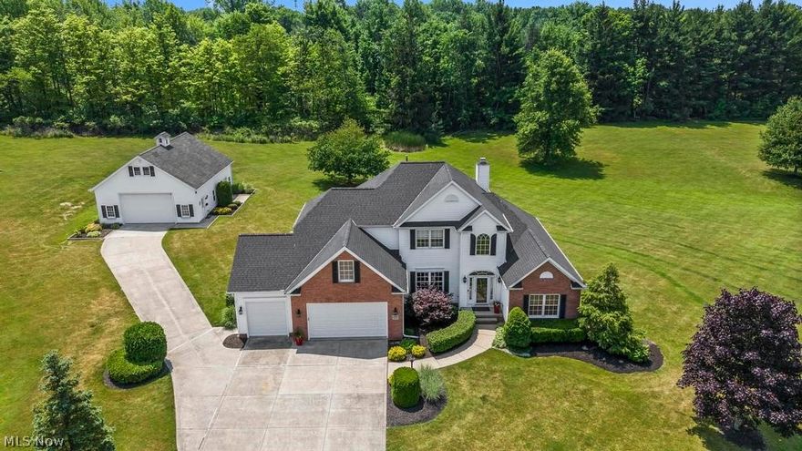 Welcome to your dream home! Nestled in the serene Grandview Estates neighborhood, this stunning one owner Colonial boasts 5 bedrooms, 2.5 baths, & a finished basement totaling just over 4500 sq ft of finished living space on 3.25 acres. Step into elegance as the two story entryway leads to a first-floor office & a spacious dining room with beautiful crown molding. The kitchen is a chef's delight with ample cabinets with pull out drawers, a large pantry, & stainless steele appliances including a beverage fridge. The dinette has plenty of space for seating & leads out to a freshly stained deck overlooking the vast backyard. The 2-story living room features a gas fireplace & custom built-ins & elegant crown molding. The first floor also features a powder room & laundry room for added convenience. The luxurious first-floor master suite boasts an electric fireplace, his & her walk-in closets, & an updated spa-like ensuite with a jacuzzi tub, walk in shower & double vanity with marble counters. Upstairs, discover 3 bedrooms, a full bath, & a bonus room/5th bedroom. The finished basement offers a kitchen/bar area, ample entertainment space, a workout room & another home office with built in desks. This property also features a 2 story 40x30 pole barn that provides additional storage for all your cars, boats & outdoor toys!  Just 8 minutes from downtown Chardon & 12 minutes to the freeway, this gem won't last long! Schedule your private tour today!