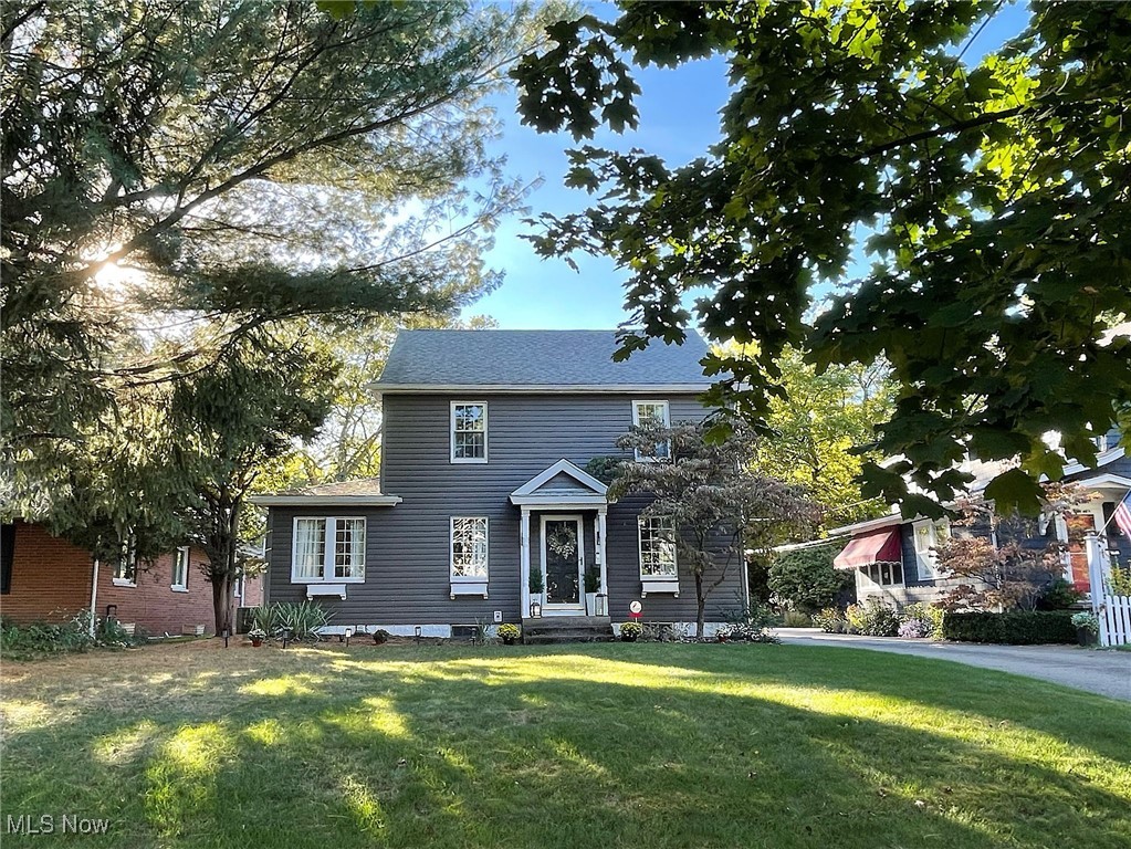 Love, care and good taste are the hallmarks of this gorgeous colonial in West Akron's sought-after Castle Park neighborhood. Brimming with character, and the compliment of carefully-chosen updates, the home will be one you'll want to make yours for a very long time. From the curb, you'll see a lovely tree-lined street and pampered yard. Upon entry, you have terrific sight lines of the 1st floor. You're welcomed by a lovely sitting area with built-ins that leads perfectly into a light, bright living room with lots of windows and natural light, a gorgeous dining room, comfortable family room and bright 3-season sunroom, which both open to the rear yard and patio. You'll have wonderful outdoor parties, here.The kitchen was very important to the owner. She had it remodeled wth a mx of modern, versatile cavinetry, including large pot and pan drawers, soft-close elements, arabesque tile backsplash, wall-mounted television, and with the kitchen island it's large enough for the cook and a couple of helpers, too! With every imaginable convenience, you'll wonder how you did without it. The second floor has a lovely master suite with three closets and a remodeled owner's bath. Two more good-sized bedrooms and an additional full bath nicely round out the second floor. Have a teenager who wants his or her own space? The third level can serve as a perfect space for a private bedroom or office. Improvements include a new electrical panel and flooring in 2025, water heater in 2022 and a full roof tear-off on the house and garage, with new gutters in 2020. Even more, the owner said she will miss the rare and precious sense of community, including wonderful public and private school options, and truly special neighbors out walking, running and riding bikes, who stop to say hello and who love being part of something special. Make plans to see this one today. You won't want to let it pass you by!