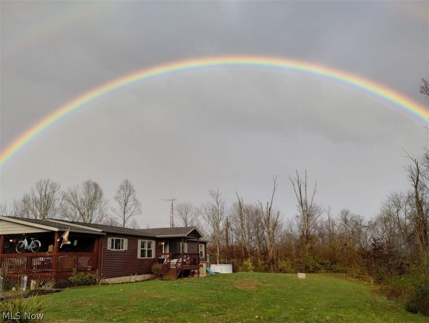 Everything you need and free gas. This 3500 sq ft  home sits on 32 acres and is situated at a dead end. Township road takes you to your mailbox and drive. Secluded and quiet with  wooded trails and open fields, but close to town, approx 6 miles to  I 77 interstate. Property features  a 3 stall barn, 2 story garage with its own kitchen , bath and laundry. and  a  24 x 32 workshop.  Manufactured home has 2 x 6 walls ,sitting on  8" poured concrete walls and has continuous gutters piped underground with 3'w x 4'd  french drain all around. 3 bedrooms, 2 baths and living room all on main floor along with eat in kitchen and pantry. Spacious kitchen deck is perfect for entertaining. Basement features a 26 x 28 family room with a 3 sided gas fireplace and a walkout concrete  patio overlooking woods.  There are 3 bonus rooms being used as bedrooms and playroom downstairs, also furnace, hot water tank in separate room large enough for storage, safes, freezers.Laundry room has half bath and laundry hook up on main floor as well.  There are 2 wells on property.  deep well is on lease but has been inactive and shallow is maintained by owner for free gas. Garage and workshop are both heated with a whole system generator between.  Water source is a well fed by 2 veins and has never run dry but city water is available . Above ground swimming pool and  play area w treehouse, and trampoline. This place is perfect for hunting, horseback riding, ATV's .  Located within Fort Frye Schools.
