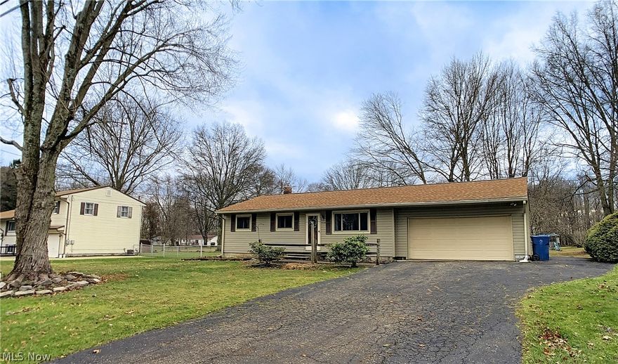 This is the one you've been looking for... one level-living with land and only the cosmetic work to do.  Come see this 3 bedroom, 1 1/2 full bathroom Ranch in a quiet neighborhood in Ravenna. It's just a quick car ride to Downtown Ravenna's "Main Street Mile" and all of Kent State's amenities. When you walk through the front door, you will first notice the abundance of natural light and the openness of the floor plan. Also surprising are the 2 bathrooms, one in the hallway and one "ensuite" in the designated owner's bedroom. The dining area has a sliding glass door that leads out to a deck overlooking a 1/2 acre of land. This home has been with the current owner's family for decades and has been well taken care of.  The roof and hot water tank are from 2019, sump pump in the basement (2017) and A/C (2015). Even though the home is a very manageable 1,000 ft2 on the first level, it has 600 ft2 of livable space in the basement (just needs new flooring!) and plenty of storage. The attic ha