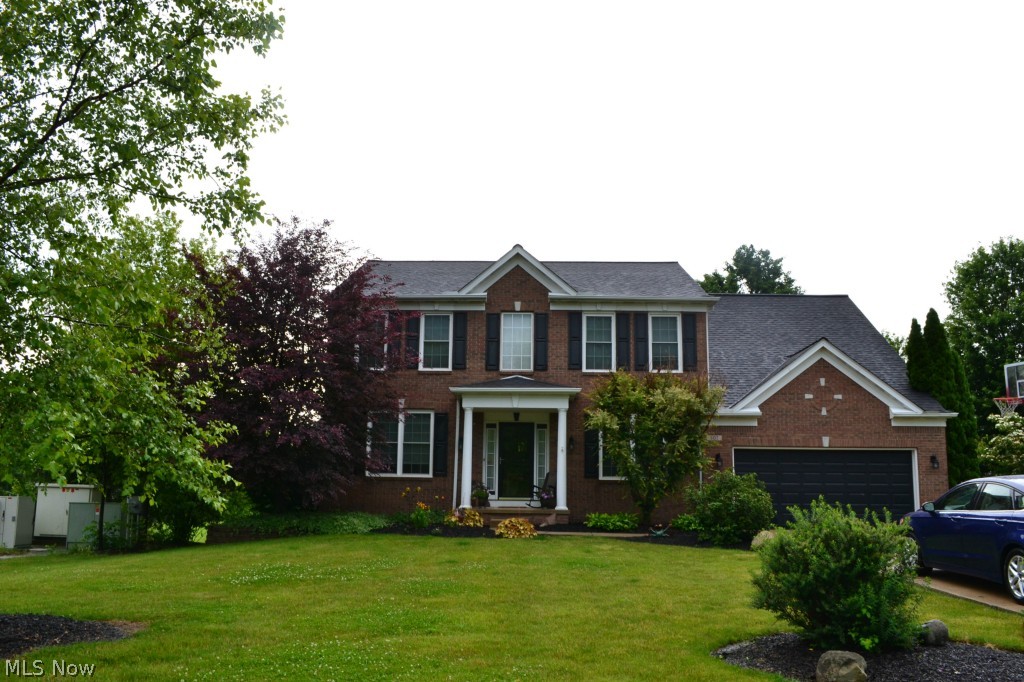 Pulte Built, The Sterling Model. Fantastic condition in this 4 bedroom, 3 1/2 bath Colonial situated on a beautiful lot with green space & walking path. Spacious finished basement in 2002 with kitchen, full bath, rec area & storage. Tastefully decorated. Kitchen has nook/eating area with a new patio door; overlooking the spacious deck and beautifully landscaped lot. Beautiful gas fireplace in family room. 2 story foyer. Windows in 2010; roof complete tear off in 2012; hot water tank 2013; new electric panel 2012. Mud room was originally part of the garage, added all oak custom storage. 1st floor laundry room. Simply beautiful inside & out.