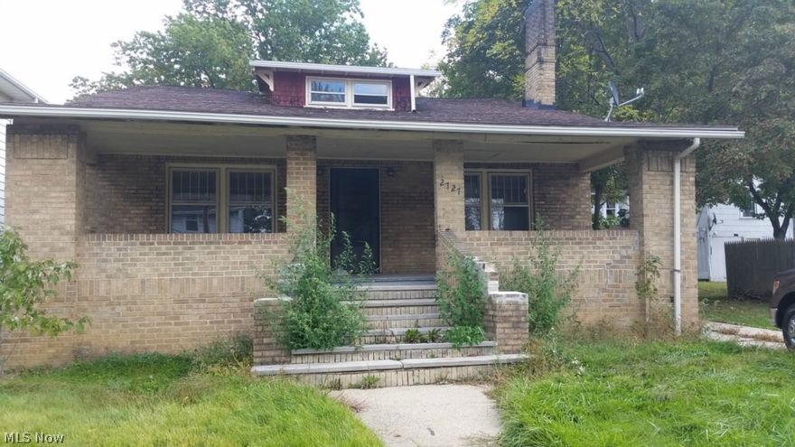 Wow - 5 Bedroom all brick bungalow with lots of original wood floors and trim, built-ins in dining room, wood burning fireplace in living room, large spacious rooms, attached 1 car garage, front porch, high ceilings, glass block windows in basement, roof is about 10 years old, great location.  Priced for fast sale.  Some updates already done but home does need work.  Hurry this won't last long.