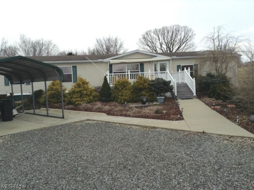 This very spacious manufactured home offers country living on 3.67 acres centrally located between Cambridge and New Concord.  Lots of natural light throughout and plenty of room for entertaining.  Attractive gas fireplace in sunken family room, roomy kitchen and living rooms.  A huge Master Bedroom and bath has adjoining bonus room currently used as an office.  Flat screen TV (wall mounted) stays in Master BR.  Front porch offers low maintenance composite decking & vinyl railing and had retractable awning/cover.  Deck is handicap accessible.  Security system in house.  A singlewide trailer (not owned by the seller) was recently moved off the property and has its own septic system.  Taxes to be assessed on home in 2014, home was surrendered to real estate in 2013. Home has a block and pier foundation. Seller is keeping the interior stained glass inserts. Seller will pump septic prior to closing.