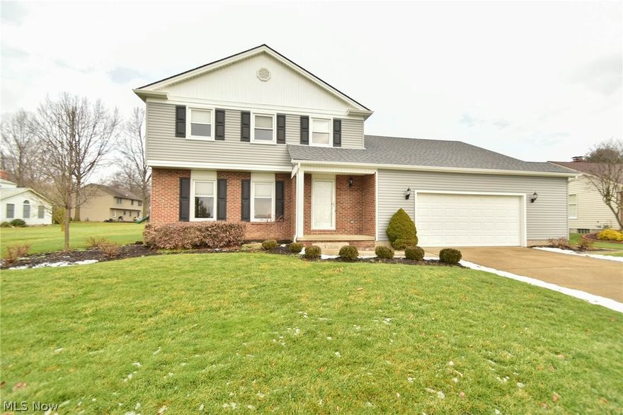 This classy Canfield colonial has charm! The exterior has almost half an acre, brick patio, double car garage with a newer roof, garage door, storm door, windows and landscaping.  Entering the home, the foyer is floored with beautiful hardwood. The stairway to the upstairs is on the right and to the left is the formal living room with white crown molding and cream carpeting.  Connected to the living room is the formal dining room with white chair rail and crown moldings. The eat in kitchen has dark oak cabinets and is equipped with newer stainless appliances that stay. The flooring consists of 18” ceramic tiles throughout and there is a pantry and built in desk area.  Past the kitchen is a fabulous family room that features a cherry mantle, brick fireplace (can use propane), and a beamed ceiling. There is a half bath, with a pedestal sink and ceramic tile on the wall and floor. Up the stairs, you find the 3 bedrooms and 1 full bath that can be accessed from the master bedroom or the ha