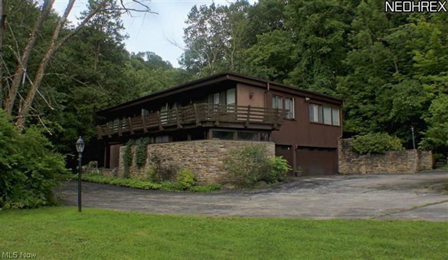 A truly unique opportunity to own this gorgeous 22 acre estate that sits alongside Yellow Creek. This one of a kind wooded property is very secluded and private and includes free natural gas. Listen to Yellow Creek and the 3 waterfalls that are part of the property from inside this mid-century California contemporary style home which offers 5 bedrooms, 4 full and 1 half baths in 5250 sq ft of living space. 3 car garage. Relax or entertain in large open area with beautiful double sided floor to ceiling stone fireplace separating the family room and living room. Natural gas is available at the street.