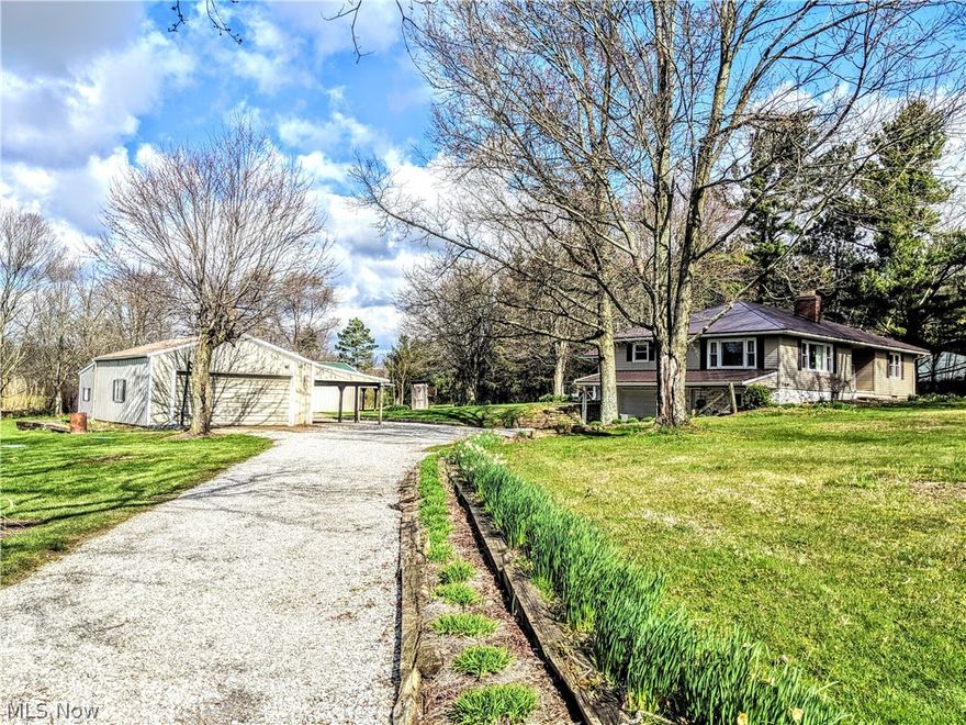Listing agent is related to seller.  Renovated ranch on 2.86 ac w park like setting that incl. creek, perennial flower beds lining the driveway & surround the property. 2 koi pools.  24x32 outbuilding w lean-to, 2-car detached garage w wood shop area & 1-carport, 1-car built-in heated garage. Chicken coop. Recent updates inside include family room conversion adds sq.ft., new windows, 200 amp service, 2 full renovated bathrooms on first floor.  Walls removed to create open concept for kitchen, dining & LR area. First floor laundry area added. New lighting, flooring, painting, FP refacing w farmhouse beam, ship lap in DR & master bath. New septic system.