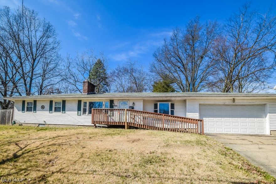 Charming ranch in West Akron, ready for you to call home! Hardwood floors flow seamlessly from the light filled living room to the dining area. Updated kitchen boasts beautiful wood cabinetry and comes fully equipped. Bonus family room with French doors to the patio, convenient laundry hook up, and direct access to the attached 2-car garage. Bedrooms feature hardwood floors, ceiling fans, and share a modern full bath. Freshly painted basement offers potential with a cozy wood-burning fireplace and room for expansion. Outside, enjoy the spacious lot and partially fenced private backyard. A must see, call today!