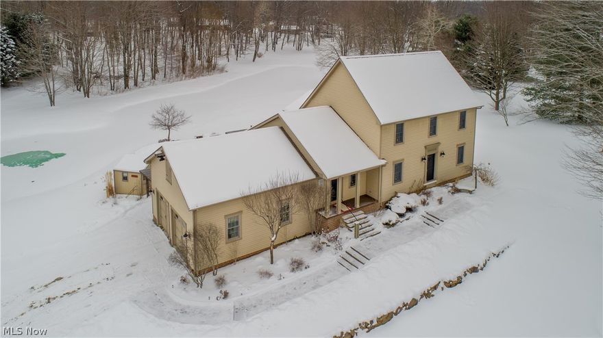 One of a kind treasure! This meticulous farmhouse colonial is unbelievably warm and inviting the minute you pull in the drive!  This home features soaring vaulted ceilings and wall of windows overlooking a serene view of water and woods!  You will love the open floor plan, huge kitchen, and dining area...plus the luxury of a 1st floor master suite!  Beautiful cherry hardwood flooring greets you in the large foyer and flows into the living area and up to the second floor.   There is also an exceptional amount of storage area accessible from the 2nd floor.  The finished lower level is the perfect place to entertain with a large bar area, family room, rec room (pool table stays) and spare room.  Lower level also accesses garage.  Additional 3 car garage outbuilding is easily accessible.