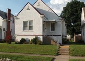 Very well maintained 1.5 story home. Neutral colors, oak floors on 1st floor. Possibility of having 3 bedrooms, but you have to go through the second bedroom on main floor to get to the upstairs. Second floor is one large finished room with walk-in closets, lots of closet space. Kitchen has oak cabinets and newer gas stove which stays with house. Bath is neat and partially updated, central heat and air in whole house, flat fenced in back yard with alley access for off street parking. Storage building in back yard. Owner has recently in 2016, put on a roof and put in some insulated windows. Also, has a large clean basement. Taxes reflect rental property, so will be less for owner occupied. Motivated seller!