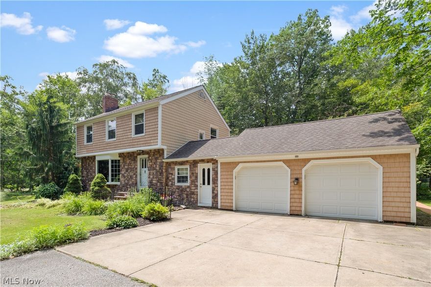Charming colonial on a corner lot in Mayfield Village. A ceramic tile entry leads to a bright living room that features a bay window, hardwood floors and a wood burning natural stone fireplace. The formal dining room has crown moulding, hardwood floors and french doors that open into an addition with vaulted ceiling, lots of windows, and an informal dining area adjacent to the kitchen. The kitchen has granite countertops, white cabinets and stainless steel appliances. The deck and yard can be accessed from the addition, as well as from the finished breezeway that connects the 2-car garage to the house. The breezeway could be easily converted into a first floor laundry or mud room. An updated half bath completes the first floor. The second floor features three bedrooms and two updated baths. A lower level recreation room is perfect for a playroom or entertaining space. Laundry and ample storage in the basement as well. Oversized 2 car garage with overhead storage. The park like serene y