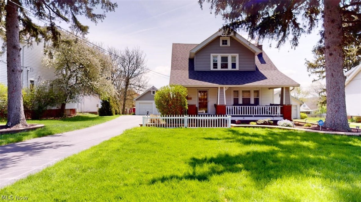Welcome to this charming Western Colonial home that seamlessly blends timeless charm with modern updates. Situated on a spacious lot, this delightful home boasts 3 bedrooms, 2 full baths, a 2-car garage, and a finished basement with a full bath. The kitchen features a spacious eating area, beautiful cabinets, a center island with bar stools, stainless steel appliances, granite countertops, and ample storage. The original hardwood flooring and wood trim add elegance and warmth throughout the home. Step outside onto the inviting 16x12 ft deck and take in the picturesque view of the expansive lot, or unwind on the stamped concrete patio with a fire pit. The living room, dining room, and den offer versatility and abundant space for gatherings. Upstairs, you'll discover three bedrooms and a tastefully renovated bath. Other recent updates include a furnace and AC in 2018, new windows in 2016, a bathroom remodel in 2021, and a roof replacement in 2022. This home effortlessly combines style and functionality. And let's not forget the large front porch, an ideal spot to warmly welcome guests. The meticulously landscaped paver flower beds add an extra touch to the already captivating exterior.