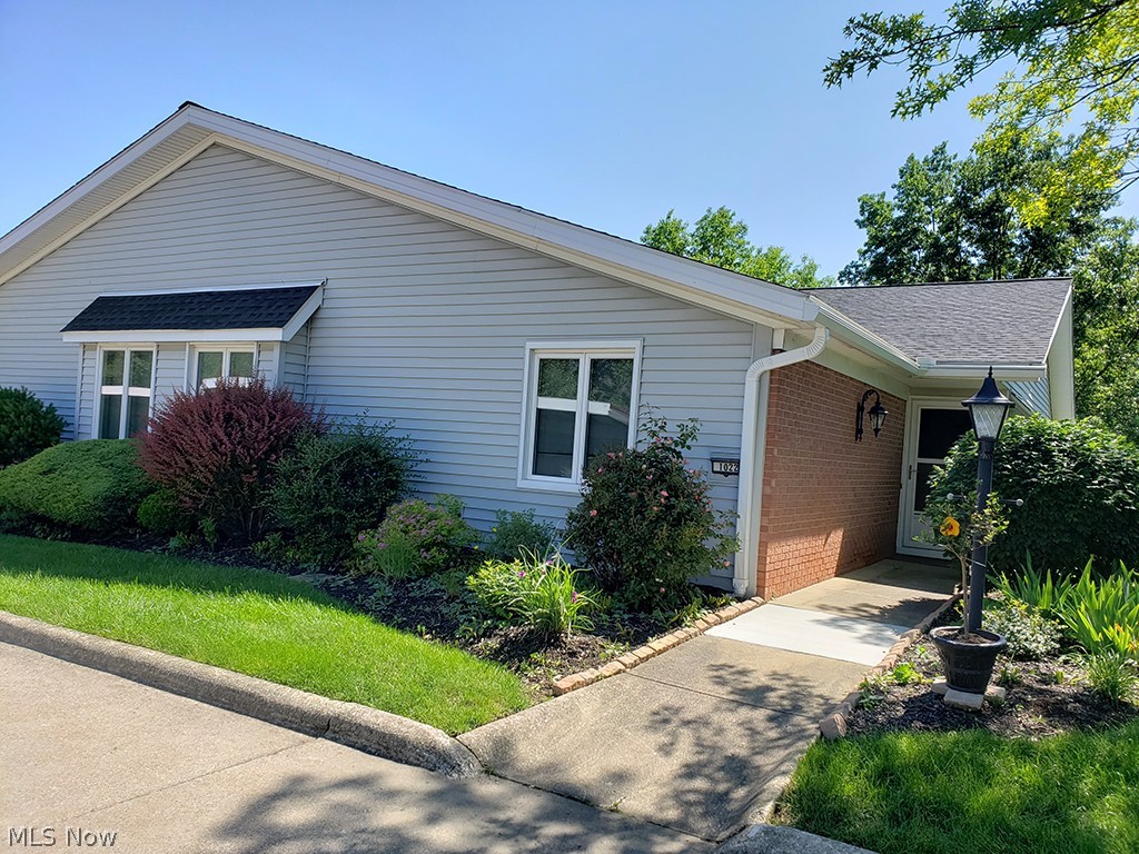 Welcome Home! Ranch style condo (end unit) with lake frontage and gorgeous lake views. Laundry is on the main level so no trips up and down stairs to wash clothes. Large private master suite with double sinks, walk in closet, easy access shower and plenty of storage. Down the hall is the main living area looking right out over the lake. Kitchen is open to dining and living room for easy entertaining. Home features newer carpet. Two outside storage spaces off deck and patio. Finished walk-out lower level with brick wood burning fireplace, built-in shelving and is open to the main level so it doesn't feel like a basement. Large patio area is a nice place to grill out. 55+ Community. Home is move-in ready. Furnace, hot water tank and a/c all new in last 3 years. Roof is also new. Don't miss this opportunity to move right in and not have to update. Call today to schedule a showing.