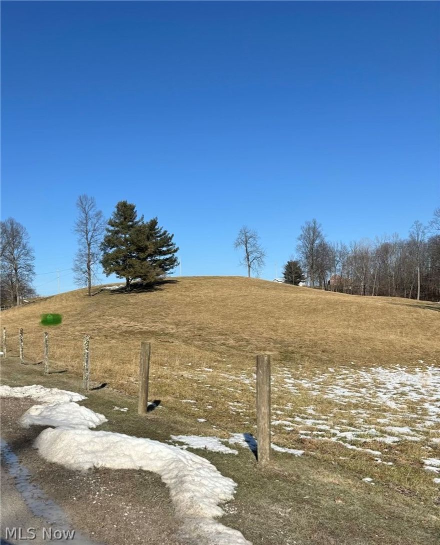 5.62 rolling acres in a beautiful country setting! Fully fenced with electric, well, and septic already in place. A picturesque location and ready for your dream home.