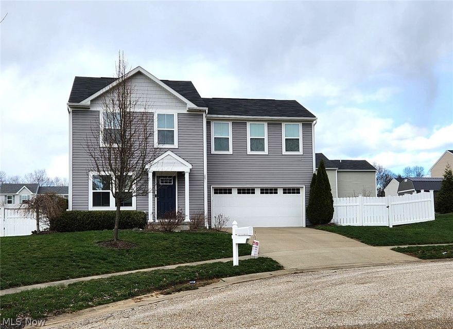 Welcome to 2671 Wintergreen Lane, a beautifully maintained 4-bedroom, 2.5-bath home situated on a quiet cul-de-sac in Ravenna. This newer property features an inviting open concept main floor with a spacious living area, dining area, and a well-appointed kitchen complete with granite countertops and a breakfast bar. New patio doors lead to a large back deck overlooking a fully fenced yard, ideal for pets and outdoor enjoyment. The professionally landscaped grounds showcase an impressive variety of plantings, including roses, lilacs, viburnum, hydrangea, rhododendron, Japanese weeping cherry, weigela, hostas, and fruit bearing cherry and peach trees. The second-floor laundry adds convenience, and the attached two car garage provides ample storage. Located just minutes from Kent State University, Highway 76, and local shopping, this 1,680squarefoot home also includes an electric mower, washer, and dryer. Situated in the desirable Rootstown School District, this property offers comfort, convenience, and exceptional curb appeal.