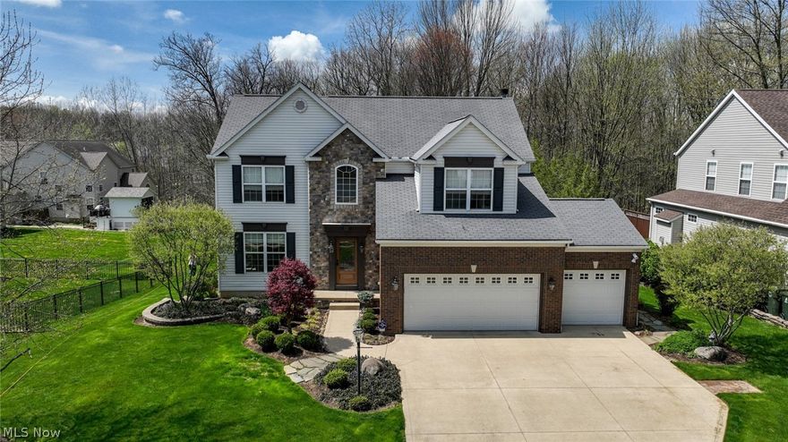 This truly JUST MOVE IN, one owner-home has it all.  Peaceful long views from large window banks, a private deck off the morning room into the woods hosting a walking trail.  Meticulously maintained, this home is packed with high end appointments that include custom Amish built cabinets, granite and stone countertops, both a center kitchen island and separate breakfast bar, Maple wood floors renewed in 2020, water softening of city water, double egress windows grace the rear basement wall adding plenty of daylight and a view onto the cement patio perfect for those private moments or entertaining, a hot water loop that never leaves you waiting, walk-in closets in every bedroom and the security of alarms on windows and exterior doors.  Warm elegance was perfectly captured in the painter's palate of professional design services.  The home is situated on one of the larger lots in the subdivision.  Thoughtfully planned and placed landscape retainers, trees, shrubs and plants are the work of professional landscapers including the installation of underground side yard lines to ensure proper drainage. Several drivers? No problem. A bonus to the 3-car garage is an oversized cement drive that will hold four cars without having to do the morning shuffle.  Call for your private viewing today!