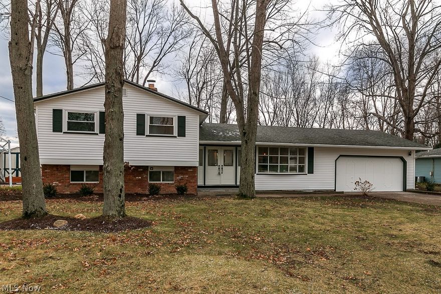 Sharp Mentor Split Level Home with all the updates! Main level has open concept vaulted living/kitchen, with Luxury flooring throughout the space. The kitchen is accented by massive quartz island, stainless appliances and tons of cabinet space. All 3 bedrooms feature hardwood flooring. The Upper bathroom has dual vanity with beautiful tiled shower and floors. The lower level offers finished family room with gas burning fireplace with additional office/play space. The second full bath has been updated with gorgeous tile and fixtures. Access the patio either off the kitchen sliding door or from the lower level walk out. Nothing to do but move in this MUST SEE HOME!