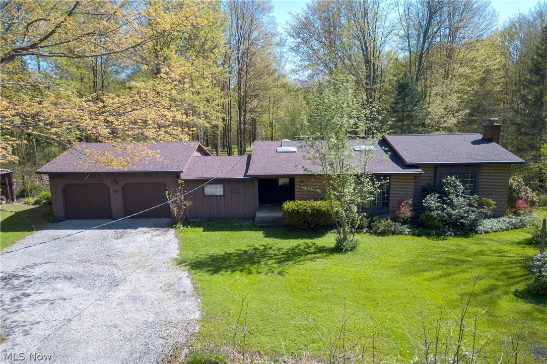 Don't let this fantastic property slip through your fingers, just minutes away from the stunning Pymatuning Lake! Situated on a tranquil one-acre lot, this property offers a spacious 1940 square foot home boasting three inviting bedrooms and one and a half baths. Enter the main residence and be greeted by the expansive open-concept, featuring a delightful fireplace and hardwood floors that flow effortlessly from the living space into the kitchen. Take a moment to unwind in the serene spa room or sunroom, offering a peaceful retreat with views of the secluded backyard sanctuary. But there's more to explore! A one-bedroom, one-bathroom trailer is also included on the property, offering potential for additional income, a cozy mother-in-law suite, or the option to create even more outdoor space by its removal. Additionally, this property offers exclusive access to the lake and dock privileges, providing you with the perfect opportunity to enjoy sunny days on the water. Moreover, the home has recently undergone updates, including a brand-new roof installed in April of 2024, fresh paint on the walls, and new carpeting in two of the bedrooms. Don't let this chance slip away to own this extraordinary retreat!