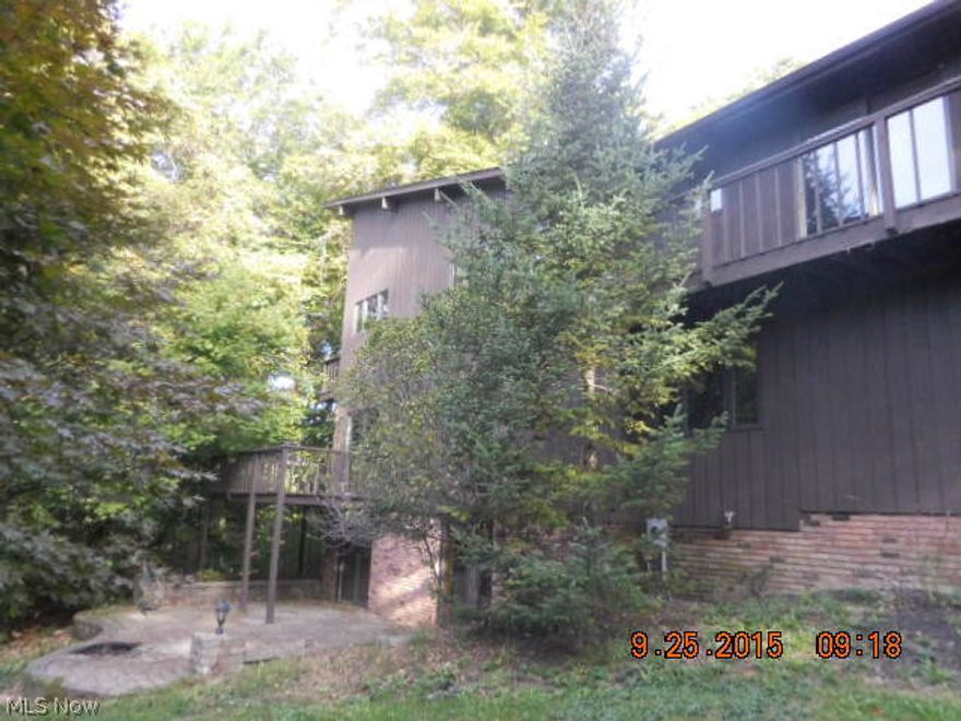 Secluded home on 9.4 private acres. Unique architectural design throughout, vaulted wood beamed ceilings. Interior needs updating. Sliders in kitchen to decking which surrounds most of this home. The 2 story master bedroom is expansive w/cozy fireplace, full wall of windows, vaulted wood ceilings, private bath, Jacuzzi & deck access. Finished walk-out lower level includes fireplace, half bath, opens to stone patio and glorious views. Some renovations. Potential to be a truly fabulous home located on a private, peaceful, perfect setting!