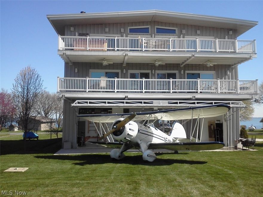 Price reduced to $725,000. The Hanger House. The ultimate in luxury living and room for your toys. The upper two levels are the living spaces, the ground floor contains temperature controlled hanger, garage, and office spaces.  Choose to live in this spacious home yourself or partner with others.  All living spaces and each of the 4 bedroom opens onto one of the four huge decks. The upper level includes a beautifully appointed gourmet commercial kitchen and walk in pantry. This open concept kitchen, dining room, living room and deck make a great place to relax with friends. Beautiful granite fireplace uses gas or wood. The master suite is on the third level. The second level contains an open concept living room and lounge, a modest kitchen, and 3 large bedrooms, each with an ensuite bath. A 40 ft hydraulic lift hanger door. Bring your plane directly from the paved 3W2 taxiway to your door.