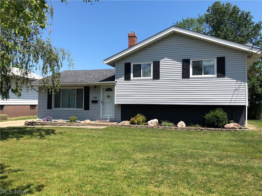 Welcome to this beautiful move in ready home on a quiet, convenient street in Brook Park. This 3 bed, 2 bath split level features a 2 car garage with newer garage door, fenced in yard with swing set and garden area, and a large freshly stained deck perfect for summer BBQ’s! The immaculate landscaping adds to the curb appeal of this charming home. The spacious living room will wow you with its original hardwood floors, luxurious vaulted ceilings and large picture window which provides abundant natural light. The living room opens to the remodeled eat-in kitchen (2014) with granite countertops, soft close cabinets, and SS appliances that stay! The hardwood continues in the upstairs hallway where you will find 3 bedrooms with new carpet (2022) and generous closet space as well as a full bath. The lower level features an updated family room (2021) with gas fireplace, custom built in desk, wet bar with mini fridge, and a walkout to the large deck – great setup for entertaining! The laundry