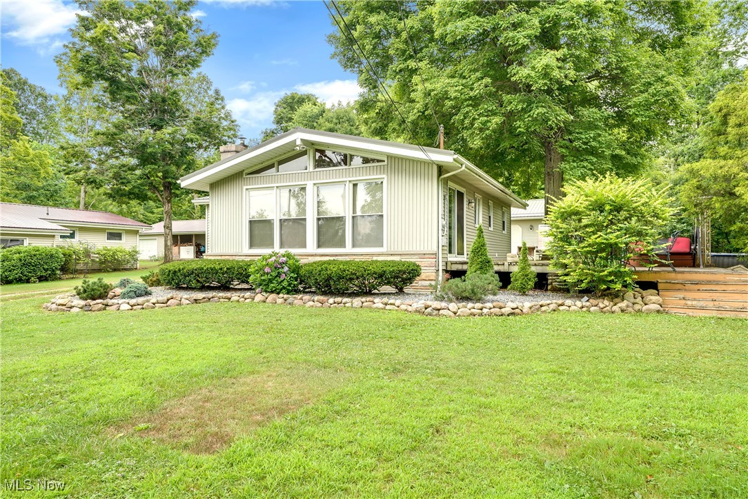 Fabulous opportunity to own a home in the second row from Pymatuning Lake! This beautiful property features large trees, a nice setback from the quiet road, a small seasonal creek, and a short walk or ride over for private/lot owner access to the Lake. The property itself is on 2 parcels that equal .78 acres of privacy along with a huge 40x28 garage that has its own bathroom! The interior of the home has a warm cabin/lake house feel that features a large stone fireplace with wood burner insert, lots of windows, and true 1 floor living.