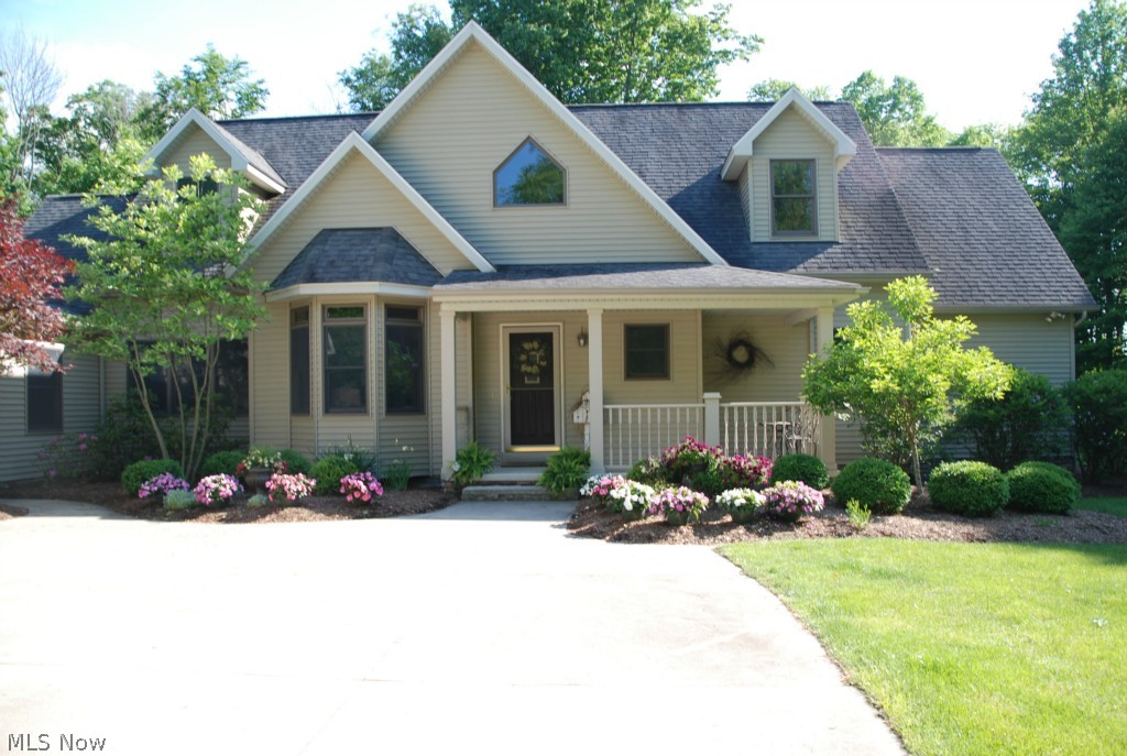 This pristine custom home exudes tranquility on over 8 acres of secluded woods. Enjoy the peacefulness from the brick patio with outdoor fireplace or take a nature walk down the path to the stream in the woods. Attention to detail is not lacking on the inside of this 4,290 sq ft home! You will love the open floor plan, dramatic ceilings, and inviting atmosphere. Built in 2002 this home features cherry woodwork throughout, solid 6 paneled doors, great room with stone fireplace, cherry kitchen with stainless appliances, double oven, corian countertops, and large island, formal dining room and casual dinette area, first floor laundry with cabinetry, 1st floor master suite with large walk-in closet, bath with double sinks and Jacuzzi tub leads to private closed in porch, cheery sun room, office (or fourth bedroom), formal living room, impressive staircase leads to two large bedrooms and full bath. Plenty of storage in the three car garage with second floor. This home has it all. If you
