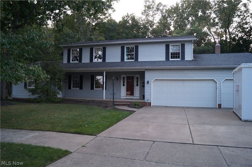 Double parcel lot backing directly to the Metroparks. Beautiful wooded and creek view. Dedicated in-law suite with living room, full bath, bedroom, wet bar area, separate entrance and enclosed sunroom/porch and deck. Full 12-course basement with partially finished rec room with wet bar, 1/2 bath (plumb for and shower stall started), utility room, additional partially finished space, workshop and slider that walks-out to huge multi-level deck. First floor laundry. Open concept kitchen/family room with updated fireplace and marble surround with beautiful all wood mantel and built-ins. Newly carpeted living/dining room, family room and stairs to second floor and hallway. 5 additional bedrooms and 2 full baths (guest and master).  3-car garage with exterior access. Huge multi-level deck for entertaining and front porch. Newer roof, furnace and a/c.