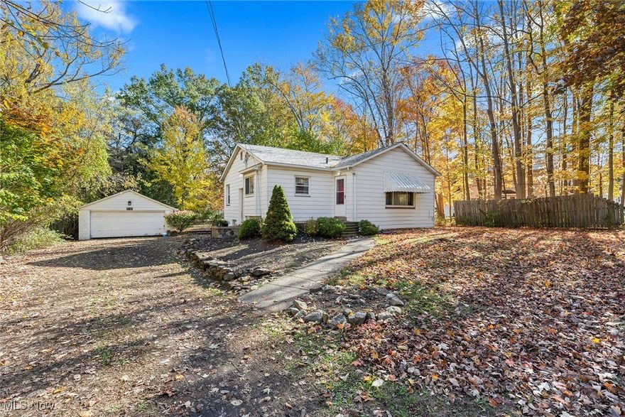 Better hurry— This is the lowest price ranch style home in Stow!  2 bedrooms and 2 bathrooms.  Spacious kitchen with lots of cabinets and countertops, and room for a table!  The large living room is carpeted and has a fireplace.  The two bedrooms have oak flooring and knotty pine paneling.  There is extra space in the lower level, including a recroom and bar area.  Extras include a new water heater in 2025!  The furnace was just serviced in October!  The roof on the house, 2 car garage and concrete storage shed were all redone in October as well!  The backyard is really big, and there is plenty of parking.  This home won't last at this price!  There is a home warranty for added peace of mind.