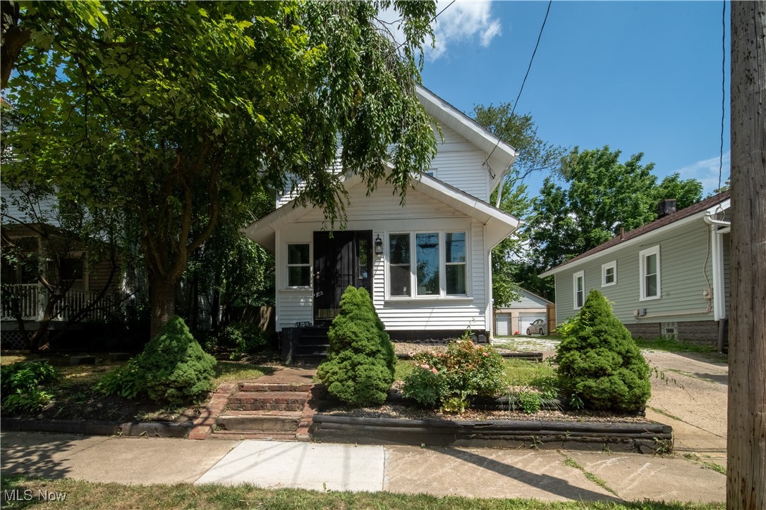 Cute, cozy and totally refreshed, this home is a blank slate just waiting for you to make it your own. The exterior is welcoming, a little walkway beckoning you inside, and as you step over the threshold (after you've wiped your feet, of course!) you're greeted by soothing neutral tones and an easy lay out. This one offers just the right amount of space to keep things comfortable, but never cramped. The main level has a darling foyer, generous living and dining rooms, and then you move through to the kitchen. Bright white cabinets feel crisp and clean, and contrast beautifully with dark countertops that will more than stand up to a coffee stain or two. This kitchen is just begging to be filled with dishes and cookwares and the aromas of a Sunday dinner. Off the kitchen, there's an enclosed back porch that your plants will be clamoring to live in or a great option for you to spend a relaxing evening, with easy outdoor access. The yard is partially fenced and feels very private thanks to a lush treeline that sits just outside of the fencing. A single car detached garage provides ideal storage space, and if you're looking for more storage space inside, the basement is ready and waiting to meet your needs. It's clean and bright and will provide your laundry area as well. Back inside we go and up to the second level. You'll find two bedrooms and a shared hallway bath. The same low maintenance flooring runs throughout all the living spaces giving the home a cohesive style, even up to the attic, where you'll find a great bonus space with endless possibilities. This adorable spot is just around the corner from multiple metro parks, hiking trails, and community ball fields. It's got easy access to shopping, restaurants, and anything else you may need. All that's waiting is for you to make it your own. So act fast, and don't miss out on this opportunity!