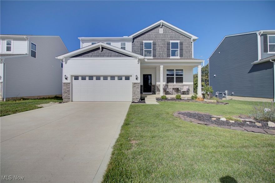 Located in Pulte's Emerald Woods Subdivision, this 4 bedroom, 2.5 bath colonial sits on a prime lot, overlooking green space, and at 2 years young, this home still smells brand new, but has some added touches beyond the builder final! With upgraded vinyl shake and stone on the front of the home. a nice front porch to relax on, & landscaping complete, the exterior is all set. The sellers added a lovely Trex deck with a gazebo and a lower level patio in 2024. The main level entry-way leads to a flex space with glass French doors and a generously sized great room with a gas burning fireplace that opens to the dining and kitchen area where you'll find granite countertops, stainless steel appliances, plenty of cabinet space and a pantry. The entry way to the garage has a built-in bench and place to hang your coats and the garage is larger in length than standard. The upstairs laundry is sure to please where there are 4 bedrooms and a nice loft space. One bedroom has new LVT flooring and the master bedroom has a feature wall and tray ceiling coupled with a walk-in closet and en-suite bath. Both baths up have double vanity sinks while the master has a walk-in, tiled shower. There is a half bath on the main level.  This home features 9 foot ceilings throughout, including the basement, where finish work has been started with drywall, the rough-in for a full bath and upgraded large windows, bringing forth the natural lighting element. This community has a park and play area and is close to Strongsville, shopping and highway access.  Move in before the snow flies and enjoy the fall scenery!