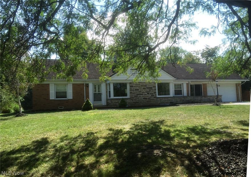 Do you love to entertain? Are you a gardener? Are you a hobbyist? If you answer yes to any of these questions, you will love this well-built, one-of-a-kind, ranch with large rooms, a rec. room with wet bar and a huge backyard with an extra garage. On cold winter nights you will love the large dual wall fireplace in living room and family room, and in the summer the enclosed porch. Updates include: windows, appliances, ceramic tile kitchen floor, bath, central air, boiler and hot water tank. The 2-car attached garage has a 1-car back opening leading to a concrete boat pad.