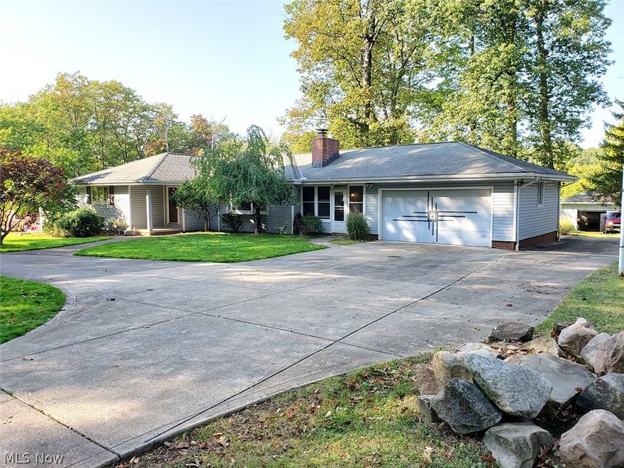 THREE BEDROOM RANCH WITH SHOP BUILDING AND SCENIC VIEWS - This updated ranch home with three bedrooms and two full baths is nestled away on a private dead-end street. Situated on a beautiful 2.48-acre lot, the home is set back off the road, having a large front yard with many mature trees. The backyard features a nice deck, oversized patio with built-in sandstone fire pit, and an amazing view of your very own slice of nature. Plenty of garage space with the two-car attached garage and a two-car detached cinderblock shop building in the back. Enter from the finished breezeway with nature stone floor to your updated kitchen, complete with stainless appliances, additional built-in storage, and a sliding door to your back deck. From the large living area with fireplace you can make your way to the three bedrooms down the hall, the oversized master bedroom having access to the full bath, equipped with a separate shower and jacuzzi tub. Downstairs you will find the laundry room with a full b