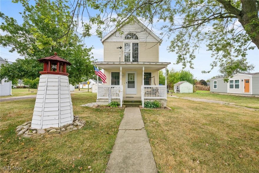 Charming Victorian style home with modern touches! This custom-built beauty features classic vinyl siding, an eye-catching fish scale gable and decorative lighthouse that illuminates your front yard. Inviting front porch to relax, read or simply enjoy nature. The first floor offers a spacious kitchen, dining area, living room and convenient half bath. The second floor includes primary bedroom, second bedroom, and full bath. Durable laminate wood flooring throughout. Recent updates include a new wood deck, ideal for entertaining, as well as newer furnace and heat pump (2022). This property includes two parcels plus two storage sheds.