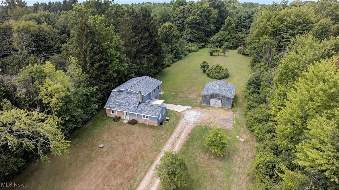 Charming and updated 3–4 bedroom farmhouse just under a mile from Lake Erie and surrounded by local wineries, situated on over 1.5 acres in the Madison School District. This 1800 sq ft home features two spacious living rooms, a formal dining room, two full baths, a laundry room, and a flexible bonus room perfect for a home office or 4th bedroom. Large second story deck off master bedroom has an amazing view of the beautiful and serene lot. The 24x30 detached garage offers ample space for vehicles, toys, workshop, or even a future horse stall setup. Numerous updates include a brand new roof on both the house and garage (2024), new water heater (2025), and extensive repairs already completed, just waiting for your finishing touches. Additional perks include a 30-amp generator hookup, backup sump pump power supply, public water plus a functioning outdoor well. Concrete block construction on the first level adds durability. With plenty of open space for gardening or animals, this property is ideal for anyone looking for a little room to roam! Call today to schedule a showing before it is gone!