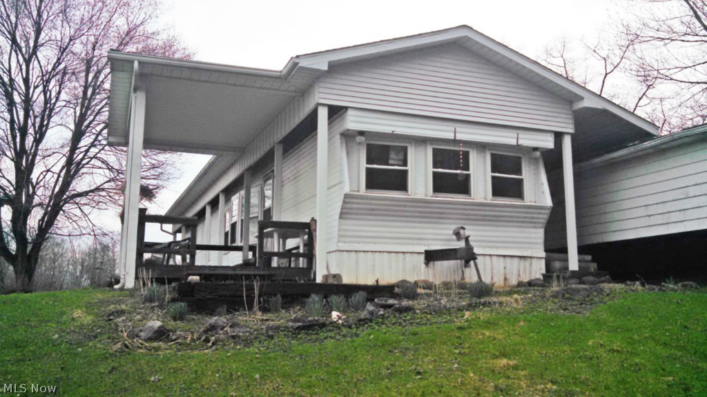 One acre with a 1973 single wide mobile home having 2 bedrooms, detached 3 car garage and asphalt driveway. Country setting. Well and septic. Affordable property. Sells AS IS!