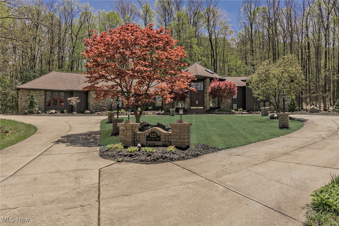 Welcome to this stunning property, nestled on 3 lush acres in upscale Eagle Ridge, an executive community in Concord. Thoughtfully designed for both grand entertaining or intimate moments, this one-of-a-kind property is surrounded by towering trees - the ultimate in privacy. Open, sunlit floor plan w/new white oak hardwood & tile floors, plus many more improvements & upgrades. Great Room boasts vaulted beamed ceilings, and dramatic floor-to-ceiling stone FP, flanked by tall windows framing breathtaking views. Gourmet Kitchen, adorned w/cherry cabinetry & granite counters, includes center island, planning nook & pass-thru buffet. Brand-new stainless-steel appliances—dishwasher, microwave, double ovens, gas cooktop, LG refrigerator are included, plus a wine cooler, and adjacent Pantry. Breakfast Room, surrounded by windows, presents serene views of the forest, creek, pond, & petite waterfall. Formal Dining Room is generously-sized, while main-floor Family Room showcases 2nd stone FP, wet bar, built-in bookcases & sliding glass doors leading to backyard oasis. Renovated Guest Bath, large Laundry Room & ample closets complete the 1st floor. Master Suite is truly a retreat & includes a spa-like slate-floored Bath, dual vanities, his-hers walk-in closet, tiled shower, and corner soaking tub overlooking the landscape. The nearby Office is ideal for remote work or creative pursuits. 3 addit'l Bedrooms feature new carpeting and 2 updated full Baths. The beauty of this property begins with the long driveway and includes the lake, fountain, creek, bridge, patios, & forested seclusion. Notable features: 4 skylights, 3 car garage, 2 FPs, fresh paint inside & out, new knotty alder doors & hardware, upgraded light fixtures, central vac, and enhanced & extensive landscaping, and even a bocce court. Minutes from I-90, Holden Arb, shopping, dining, hospitals, Metroparks & Lake Erie, this legacy property offers a rare opportunity to create lasting memories in a breathtaking setting.