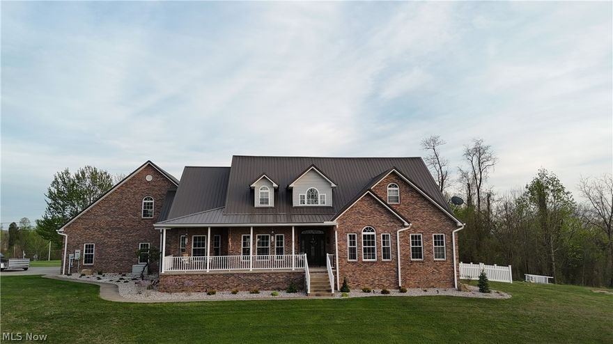 Yes! You can have it all. Just eight minutes from the city limits, this beautiful, custom brick home sits on two acres with professional landscaping. The idyllic aesthetic is overwhelming here with this 5 bedroom, 3 full and 2 half bath masterpiece. Enjoying main-floor living here is possible as the 20-foot-high entrance foyer opens into the formal living and dining rooms and draws you into the open-concept family room with an enormous custom stone gas fireplace - complete with a hand-hewn mantle from a local log cabin.  The meticulously designed eat-in kitchen is a family or entertainer's dream featuring a very functional flow with custom hickory cabinets, granite counter tops, and newer stainless-steel appliances, including double wall-mount ovens. The close proximity of the large laundry room and half bath further create ease of living. Retreat down the private hallway to the giant main-floor primary ensuite that includes French doors to the back patio and an ample bathroom, complete with a large, jetted bathtub and brand-new glass shower enclosure, or continue down the main hallway to a large main bath and two more large bedrooms. The upper floor is an oasis of its own, with two, potentially three bedrooms, a full bathroom, den, and loft area. Still seeking space? Explore the finished basement area with 1,700 additional square footage, which could be a large playroom, exercise, and theatre area, or converted to an in-law suite, or what needs your lifestyle requires. The options seem endless. This finished space is connected to a large workshop, storage area, and additional half bath with walk-out access to the garage. Don't miss the above-garage finished hideaway, fashioned in an old-English pub style. This home isn't just beautiful; it has an extremely functional floor plan and is perfect for entertaining both large and smaller, more intimate gatherings. Schedule a tour today and begin dreaming. OLREA