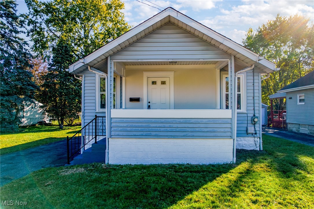 Welcome to 787 Ravenswood! This fully updated home is set on a double lot with mature trees and a convenient turnaround driveway! Step inside to find a bright, welcoming living room with neutral tones and warm natural light. The renovated kitchen features sleek countertops, all-new stainless steel appliances (2025), new fixtures, and a perfect flow into the dining area with a built-in glass hutch. Three well-proportioned bedrooms and a remodeled main bath showcase a clean, modern finish. Recent updates include a brand-new roof on both the home and garage (2025), fresh paint throughout, updated lighting, and new flooring for a move-in-ready feel. The full basement offers plenty of space for storage, as well as a convenient second bathroom and has a ton of potential for finishing down the road. Enjoy quiet mornings on the covered front porch or take advantage of the expansive yard space ideal for outdoor living, gardening, or future additions. The detached garage provides easy access and extra storage. Conveniently located near Firestone Park, local schools, dining, and highway access, this home offers space, function, and lasting value in a prime Akron setting. *Property is agent owned