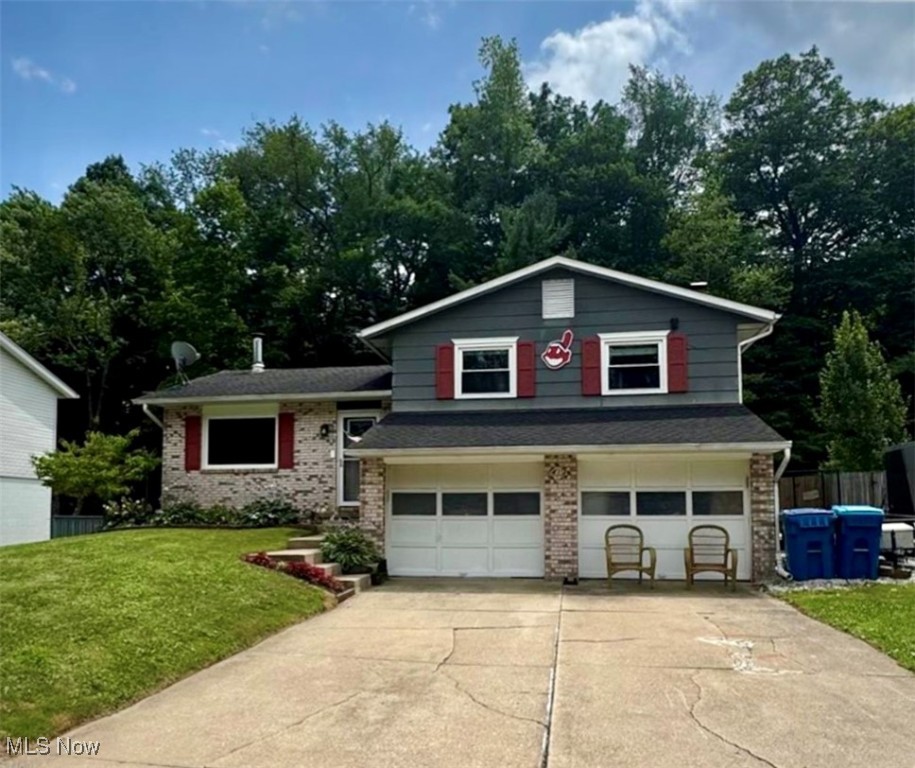 Welcome to this beautifully maintained 3-bedroom, 1.5-bathroom split-level home nestled in a sought-after neighborhood of Canal Fulton. Backing up to a serene wooded area, this property offers peaceful views and a private backyard retreat. Inside, you’ll find three spacious bedrooms and an updated full bathroom on the upper level. The main living room features a cozy fireplace, perfect for relaxing evenings, and flows into a well-appointed kitchen with patio doors that lead to a large deck—complete with a hot tub—overlooking the expansive backyard. The lower level offers a generous family room with a second fireplace, convenient half bath, and walk-out access to the backyard, making it ideal for entertaining or relaxing. Additional perks include a lower-level laundry area with hookups, tons of storage space, and a 2-car attached garage. Don’t miss your chance to own this charming home with space, style, and views in a location you’ll love! Schedule your showing today! Roof, HVAC, updated kitchen and appliances approximately 10 years old. Deck and hot tub 7 years old. Updated main bathroom with large walk in shower 2 years. (section of new fencing going up soon in backyard)