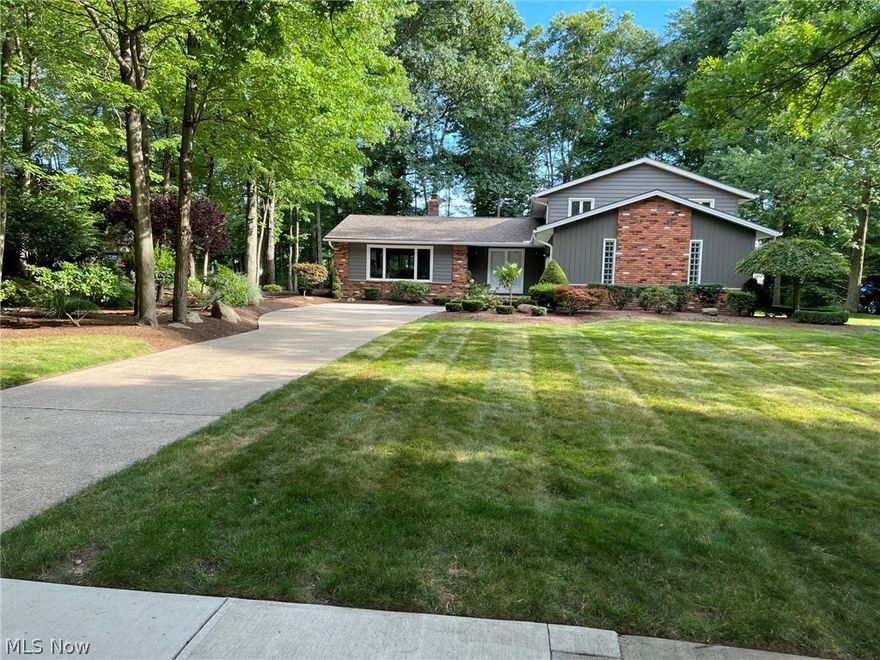 Rare gem in Beautiful Aintree Park, Mayfield Village 4 bedroom 2.5 bath home. This well maintained home boasts over a half acre wooded lot and beautiful landscaping. The main level features your traditional living, dining room and kitchen with all stainless appliances, including double ovens. The Kitchen is open to the large lower level family room with a beautiful fireplace. Access the stamped concrete patio and beautiful backyard from the family room for indoor-outdoor entertaining. 1st floor bedroom is being used as an office with built-in cabinets and desk. Updated half bath and mudroom complete the lower level. The upstairs features a large master suite with an updated bath and walk in closet. In addition to the master, the upstairs has 2 more large bedrooms and another updated bath. The basement is finished with a cozy TV or play area. Plenty of storage. Many improvements, newer vinyl siding, windows, insulation to name a few. This is a must see.