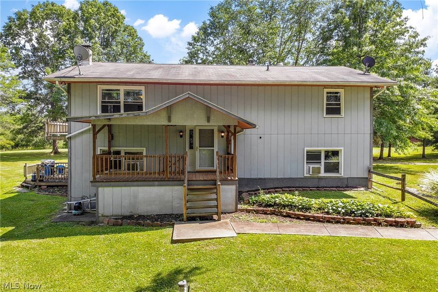 Unique Opportunity!! Here is your chance to live in a desirable area of Rootstown Township with easy access to highways, public services, shopping, Windmill Golf Course, West Branch State Park, and NeoMed – with room to grow! This 5 bedroom/2 bath home is situated on nearly 2 acres in a serene country setting. The privately situated home sits back off the road and greets you with not just one, but two decks overlooking the expansive grounds.  The entry from the driveway includes a striking enclosed poured cement patio and veranda, that could double as mudroom. The first floor includes 2 beds, a full bath, kitchen, dining, and living room and direct access to the full basement, laundry area, and lower deck. The second level also features 3 bedrooms – 2 with veranda access to the patio – and a second full bath, kitchen, living room, and dining room with deck access. The front of the home has a large porch that is perfect for viewing the abundant wildlife and natural landscape this home p