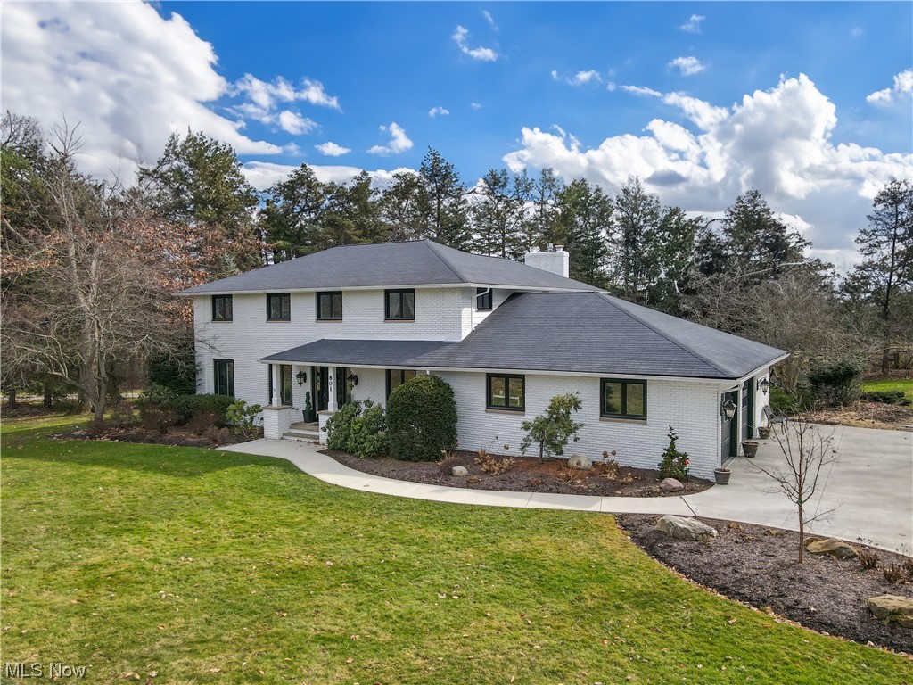 Welcome to this beautifully updated 5 bedroom,2 full,2 half-bath colonial home in the heart of South Russell. The remodeled 1st floor lends itself to effortless entertaining with an open floor plan and over 2000 sq ft of living space. The updated kitchen features custom cabinets, granite counter tops and stainless appliances including a 5 burner Fisher & Paykel gas range. There are two islands, both with seating and the kitchen is open to a beautiful hearth room featuring a gas fireplace surrounded by a gorgeous stone wall and reclaimed wood mantle. The expansive dining area can accommodate even the largest of tables. This space also features a conveniently located beverage bar with 2 beverage drawers, illuminated cabinets and loads of storage. Just off the dining area is the large four-season room with a wet bar and it's own heating and cooling. the room is surrounded by glass sliders and leads to the paver patio. With high ceilings and loads of natural light, you'll never want to leave this room. The amply sized living room provides additional space for relaxation and gatherings and is adjacent to a 1st floor office. The laundry/mud room is located in the back hall of the home and has custom built ins galore. Upstairs you'll find 4 bedrooms and a full bath as well as the primary bedroom with it's own en suite bath. The walk up/out basement is partially finished and has a large rec room, an exercise room and a workshop.The attached 2 car garage is heated and offers additional storage. This home sits on a 1+ acre lot and is surprisingly quiet and private. The backyard features a patio surrounded by perennials and lush landscape as well as a picturesque pond. This home is just a short drive from the Village of Chagrin Falls and is conveniently located near Rt 306 with freeway access just minutes away. Award winning Chagrin Falls Schools! Please see supplements for updates...too many to list. This one won't last!