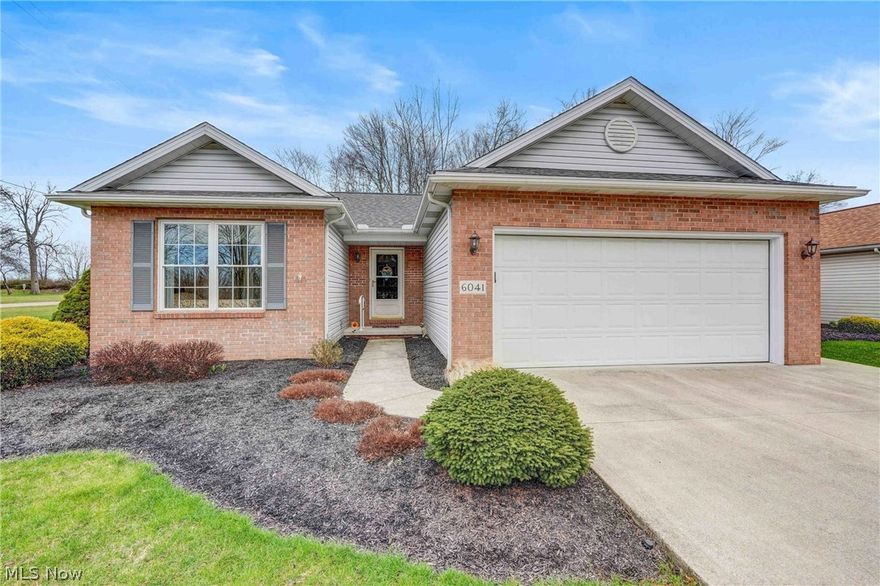 Welcome home to this immaculate 2-bedroom, 2-full bath free-standing ranch cluster home with a full basement, set in a private and peaceful location. A welcoming foyer with a generous coat closet opens into the light-filled living room, featuring vaulted ceilings and a cozy fireplace. The spacious eat-in kitchen offers expansive Corian countertops, a newer stainless-steel refrigerator, abundant cabinetry, and all appliances remain. Convenient main-floor laundry is located just off the kitchen, with the washer and dryer included.  The full, unfinished basement provides unlimited storage, is plumbed for a full bath, and offers excellent potential for finishing & future In-Law suite. Two comfortable bedrooms include an en-suite with a walk-in closet.  The attached garage is sure to impress with a gas line, water, man door, and additional storage. Outside, enjoy professional landscaping and a stamped concrete patio overlooking a wooded lot. A new roof with full tear-off was completed in 2023.  The low-maintenance fee covers landscaping and snow removal, making this a truly rare opportunity. Homes like this do not come up often — schedule your appointment today.