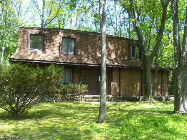 Desirable location! This 2 story, 4 bedroom 2 full and 2 half bath home in Sherman Wood estates is located on a wooded lot which offers an abundance of privacy. The formal dinning room and fire placed family room have sliders that open up to the private wooded back yard. The master bedroom offers it's own full bath and walk in closet.The lower level walk-out has a half bath and workshop area. There is a newer boiler system for zoned heating. Air conditioning units located in home do not work.Home is being sold AS IS! Seller will not do any repairs. or buyer assistance. Cash or conventional financing only.