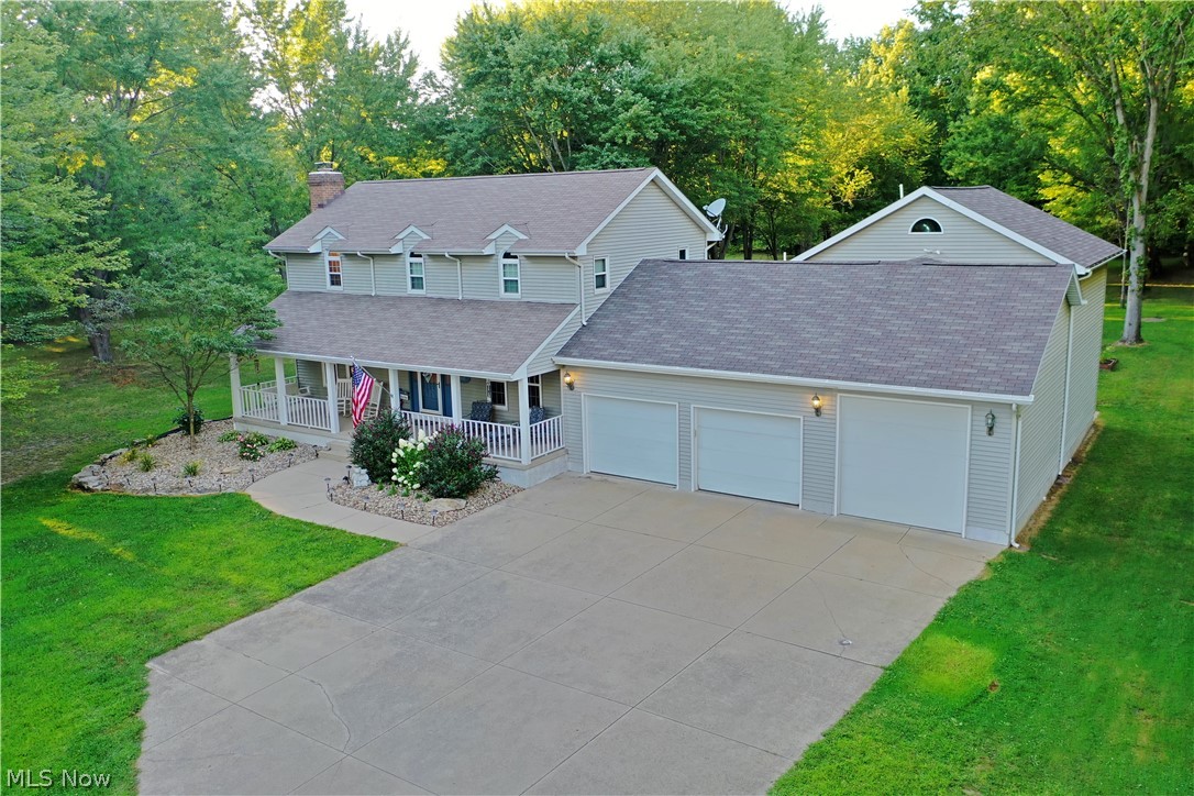 Welcome home to 8817 Howland Springs Rd Southeast! This incredible 3-4 bedroom, 3.5 bath colonial home has it all! As you approach the home on the long concrete driveway notice the mature, well maintained landscaping. A large covered front porch welcomes you as you enter the home. The foyer gives way to a large living room which features waterproof vinyl flooring (2019), and beautiful white brick fireplace with a custom marble hearth and french doors that lead to a gorgeous sunroom! The gorgeous kitchen features soft close cabinetry, granite counters, a breakfast bar and tons of storage are accented by a stacked stone backsplash (2019) and dramatic pendant lighting. Just around the corner is a powder room, laundry, and access to the incredible 4 car attached garage complete with an additional kitchen/prep area - perfect for outdoor parties! The second floor of this home features a master ensuite bedroom with a jacuzzi tub, shower and a 10x9 walk in closet! 2 other nicely sized bedrooms