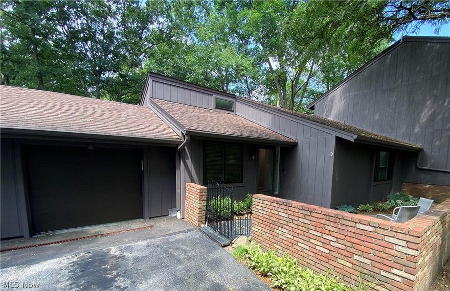 Greenwood Village living at its absolute finest. Lush natural surroundings and beautiful canyon views at your backdoor in this ranch style condo which sits just along the border of the Cuyahoga Valley National Park and is perfect for any nature lover. The brick walled front terrace provides a tranquil spot to great guests or have a chat with your neighbor while enjoying your morning coffee or evening libation. So completely remodeled in 2018 with no stone left unturned, this unit was stripped to the studs. Appreciate the tremendous open eat in kitchen, plentiful Amish built shaker cabinets gorgeous quartz counters, a complete LG suite of appliances, under cabinet lighting and charming galvanized steel pendant lights over the dining peninsula which flows seamlessly into the great room with soaring ceilings and a stunning double-sided gas fireplace with rustic hand hewed beam mantles on both sides.  The living room is light and bright thanks to the large windows and sliding patio door with motorized window treatments. You will love the impressive natural light and views directly out to the spacious composite deck and canyon beyond.  Once you've finished being awed by the amazing main spaces, make your way into the bedroom hallway where first you'll find a handy linen closet, a full guest bath with walk in shower and guest bedroom.  Around the bend you'll find the lovely and private owner's suite which enjoys the other side of the fireplace showcasing a stacked stone finish. The ensuite bathroom offers a spacious low step tiled shower and a double vanity. back into the hall descend the stairs to find a nicely sized lower level family room with full kitchen, guest suite w/ attached full bathroom, and bonus room perfect for a home office, as well as, a large utility room with updated mechanicals and washer/dryer. complete list of updates in supplements. GWV amenities include indoor/outdoor pool, tennis, clubhouse, fishing pond, hiking trails and community activities.