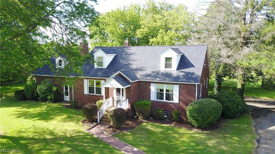 If you are looking for a little space to stretch out and enjoy the fresh air of country living, then this one is for you. Situated on 2.33 beautiful acres, this 3-4 bedroom 2 full bath brick cape cod has so much to offer.  The home boasts a newer kitchen, refinished hardwood floors, all new lighting, carpet and paint.  The electric was redone when the new septic system was installed two years ago.  The basement has another living area with fireplace and a full bath that is the perfect man cave.  Outside there is a second large garage, stocked pond, blueberry bushes and a back yard big enough to have the biggest of picnics.  This home also comes with the piece of mind of a one year 2-10 Home Warranty