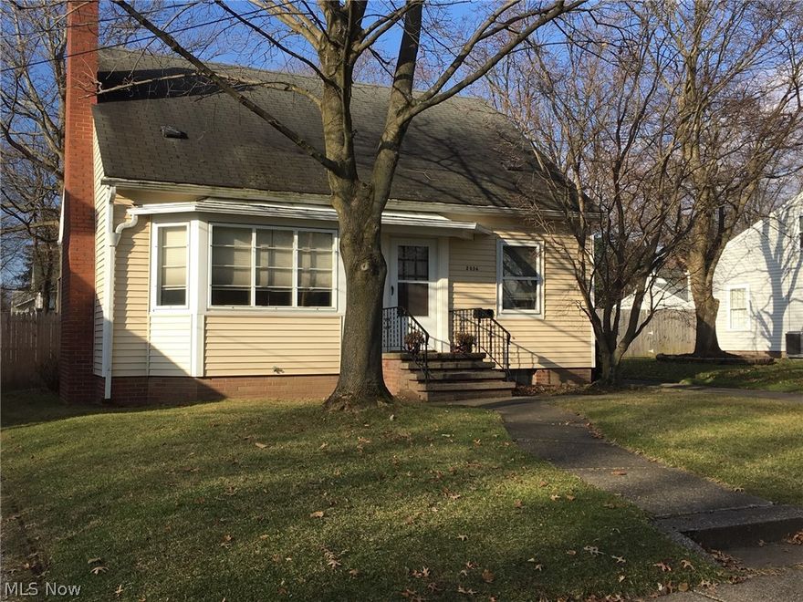Here's your chance to get into a wonderful Cuyahoga Falls neighborhood at an amazing price!  You read it right, this home has 3 bedrooms, 3 bathrooms and a large 2 car garage with a loft!  Before you come in, be sure to check out the great fenced in yard and back deck.  The retro kitchen is awesome.  With lots of cabinets, the original stainless Tracy sink, a farmhouse range with double oven and original tile on the walls.  The refrigerator, portable dishwasher and microwave stay too.  Open concept, before it was cool.  The living room and dining room share one large open space that allows you to enjoy your family/company and the wood burning fireplace. This area has a ton of windows which make it feel even bigger and brighter.  On the main level there is also a bedroom with sliders out to the back deck and a full bathroom!  Up the charming stairway to the second floor balcony overlooking the beautiful backyard, two additional bedrooms and another full bathroom!  All of the bedrooms ha