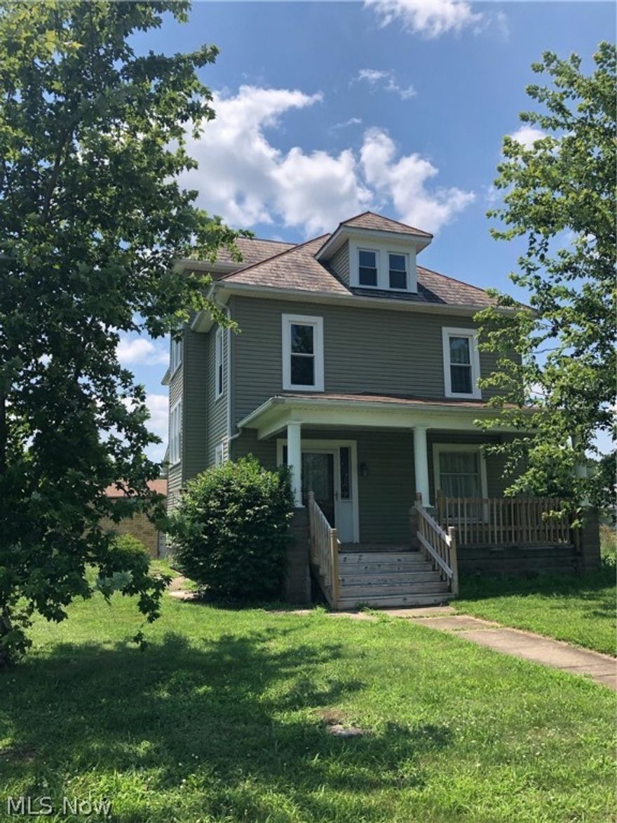 Spacious vinyl sided 2 story home. Original woodwork with pocket doors. Hardwood floors in the foyer and the living room. Decorative fireplace in the kitchen with hardwood floors.  Kitchen includes appliances.  Potential fourth bedroom in the walk up attic. Vinyl replacement windows throughout in 2016.  Gas forced air heating throughout the home with baseboard heating in the attic.  Oversized 2 car garage with 2nd floor for storage.