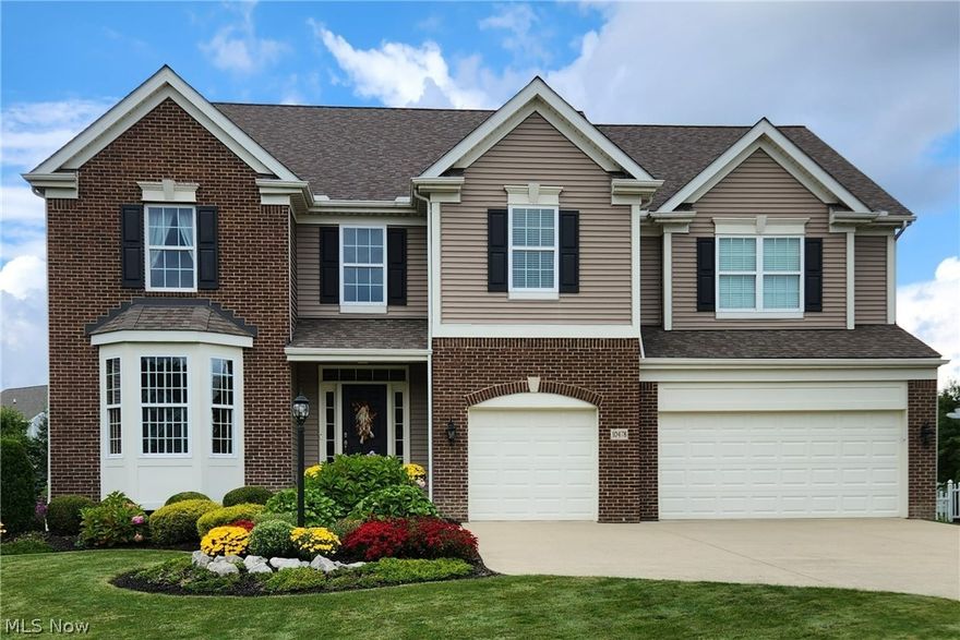 Custom built Drees home with great curb appeal and exceptional landscaping that includes a TREX deck with enclosed pergola and lattice paneling and newer 21 x 30 foot paver patio + 6 raised garden beds. Sunlit two story foyer boasts gleaming hand scraped hardwood flooring which can also be found on the staircase, office and dining room. The impressive kitchen has a large seating island, granite counters, GE Profile double self cleaning convection oven, newer backsplash, built in desk, new lighting fixtures, under cabinet lighting and beautiful tile flooring. There is a large dining area with sliding door to the deck which makes for easy entertaining. The kitchen opens to the TWO story family room with gas FP and remote Hunter Douglas shades on the 2nd story of windows. Formal dining room with crown molding, tray ceiling and custom shades. Second back  staircase from the family room leads to 4 large bedrooms. Both the master bathroom and hall bath were recently remodeled with quartz cou